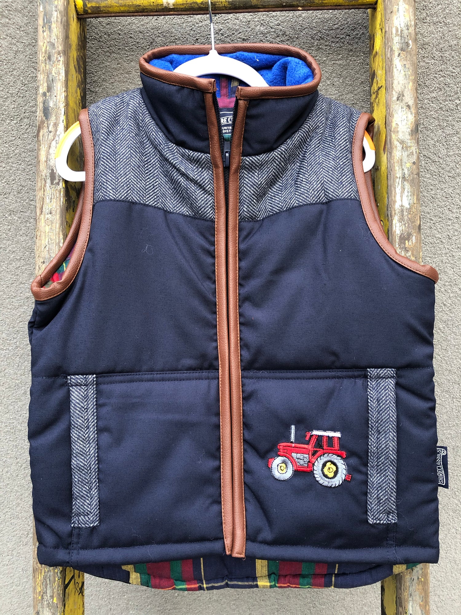 Boys Tractor Tweed Bodywarmer in Navy @ www.millscountrystore.com